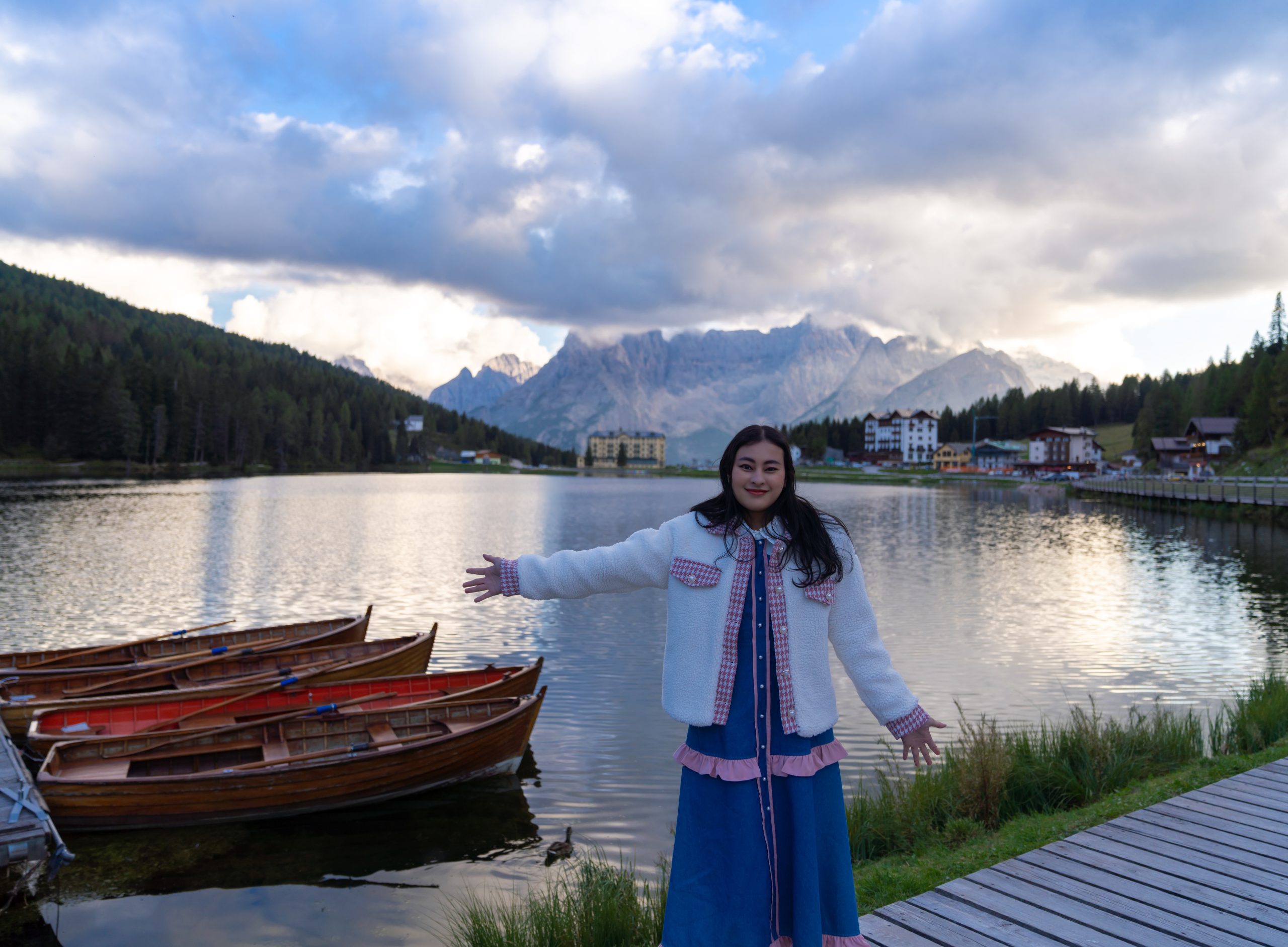 happy asian woman standing coast misurina lake dolomites italy landscape with girl reflection water buildings blue sunset sky italian alps travel background